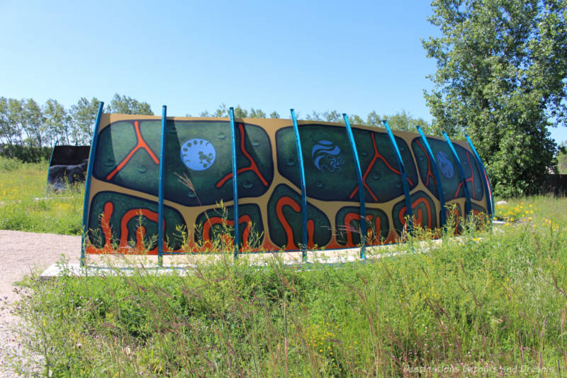 Mural painted in colours of teal, orange, and blue to resemble a turtle shell