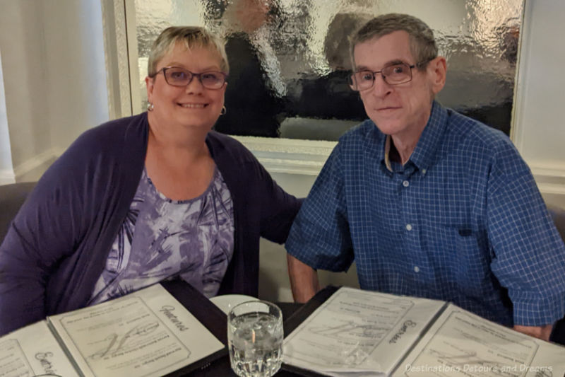 Couple seated at a restaurant table with menus on the table