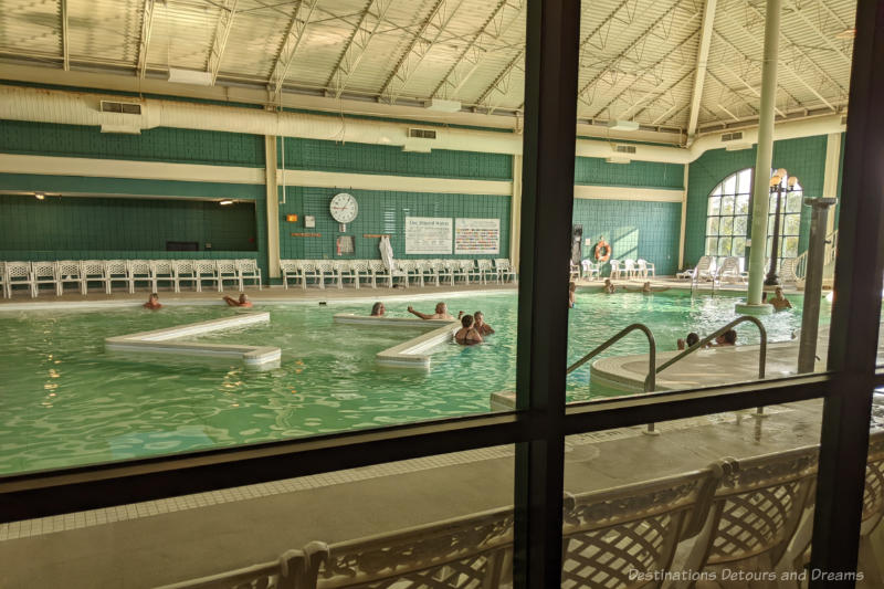 Looking through a glass window into the large mineral pool at Temple Gardens Hotel & Spa