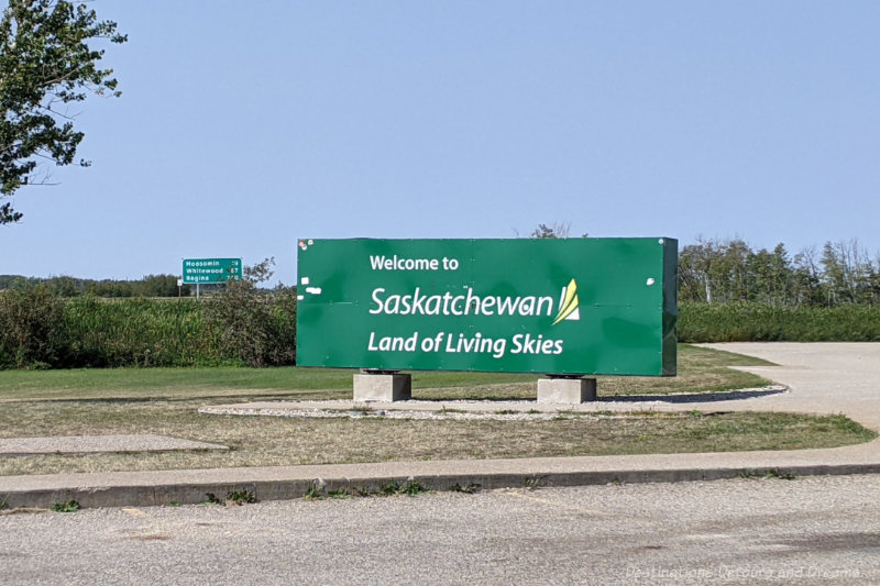 Green sign welcoming drivers to the Canadian province of Saskatchewan, land of living skies