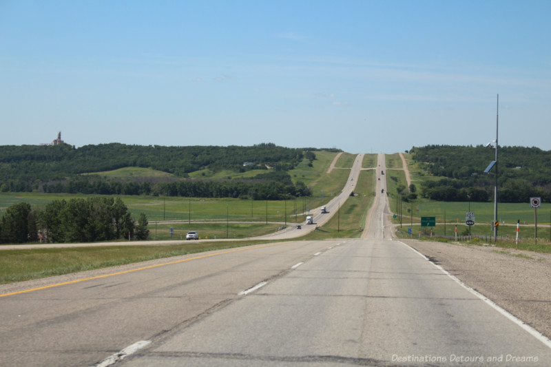 A four-lane divided highway going through a shallow valley on the Canadian prairies