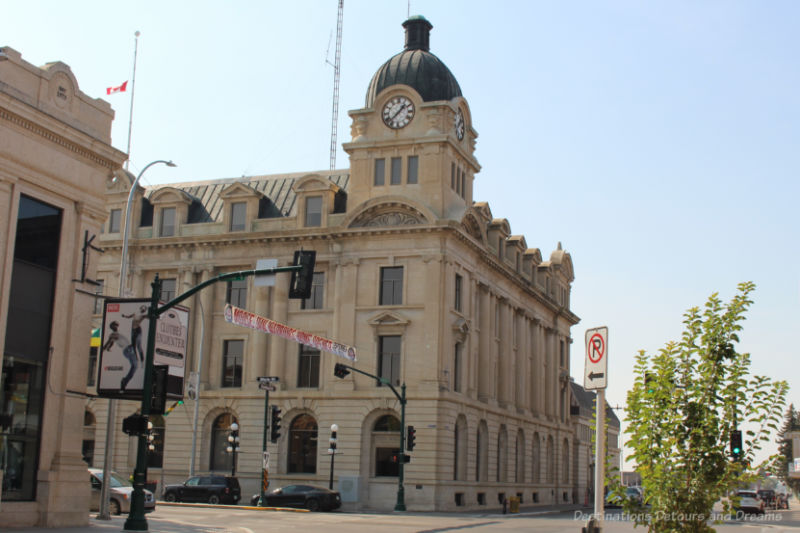 Tyndall-stone and brick clad Moose Jaw city hall with asymmetrically placed clock tower with cupola, built in the 1910s