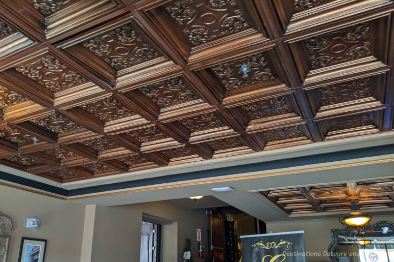 Copper-coloured intricately-decorated squares in an ornate ceiling