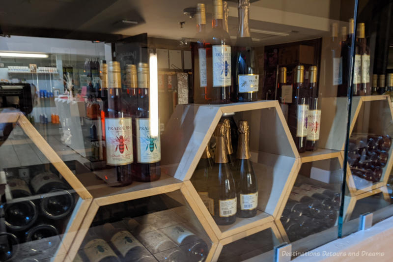 Moose Jaw Prairie Bee Honeycomb shaped wood shelfing displaying bottles of mead