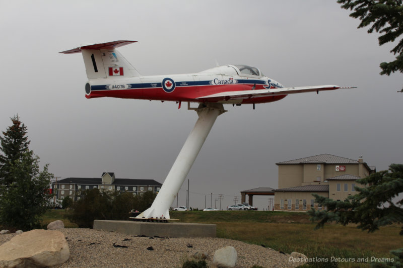 Moose Jaw Snowbirds Statue Canadian Snowbirds plane mounted on a stand to create an outdoor monument in Moose Jaw, Saskatchewan