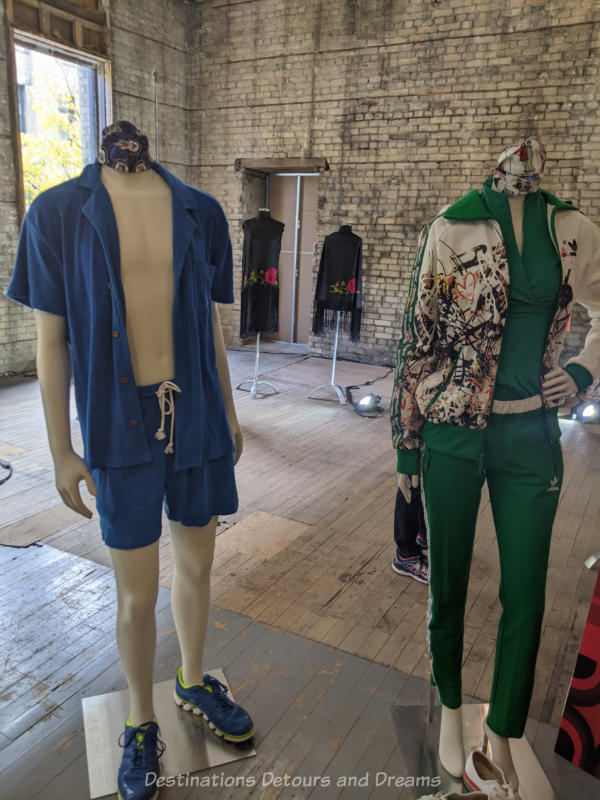 Headless mannequins wearing athletic outfits with matching face masks draped around their necks