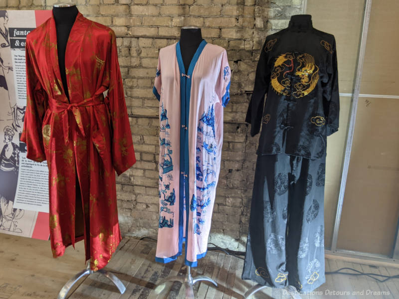 Three mannequins wearing 1920 oriental-style clothing