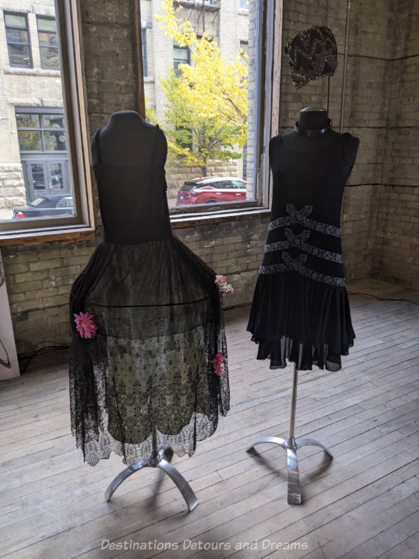 Stick mannequins wearing 1920s black party dresses