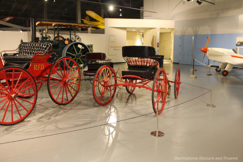 Horse-drawn carriages and a an airplane in entrance to Western Development museum