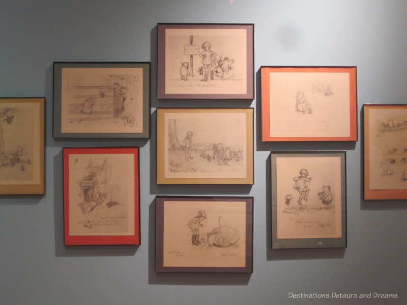 Collection of framed Winnie-the-Pooh illustrations hanging on a gallery wall