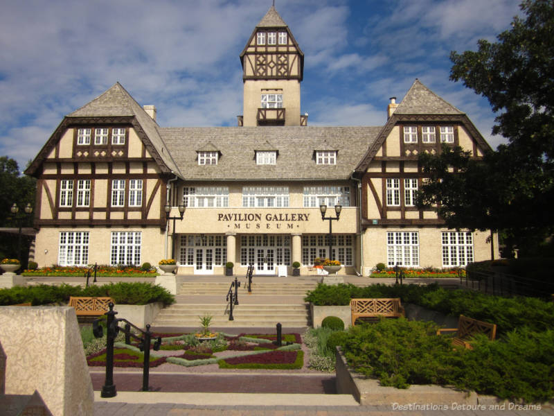 Assiniboine Park Pavilion, a large 3-story wood and stucco-clad structure erected in 1929-30 with Tudor-influences, a steeply pitched gable roof, and a square tower in the centre