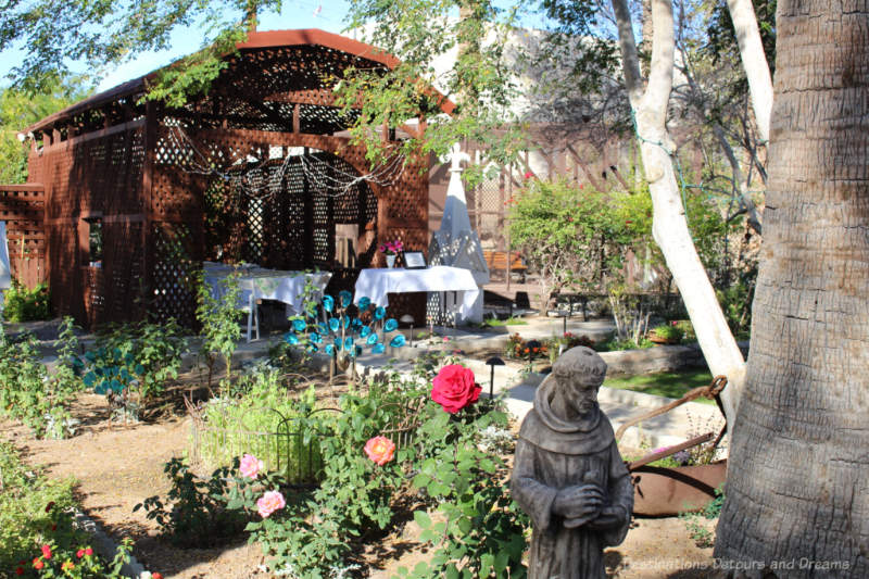 Garden with vintage roses and covered dining area at Sanguinetti House Museum