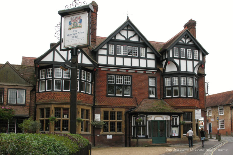 Three-story red brick and black and white timber hotel in English village