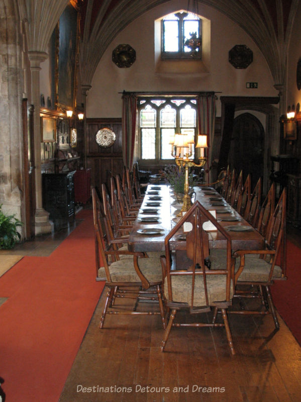 Victorian-era palace house dining room with vaulted ceiling and long table with wooden chairs