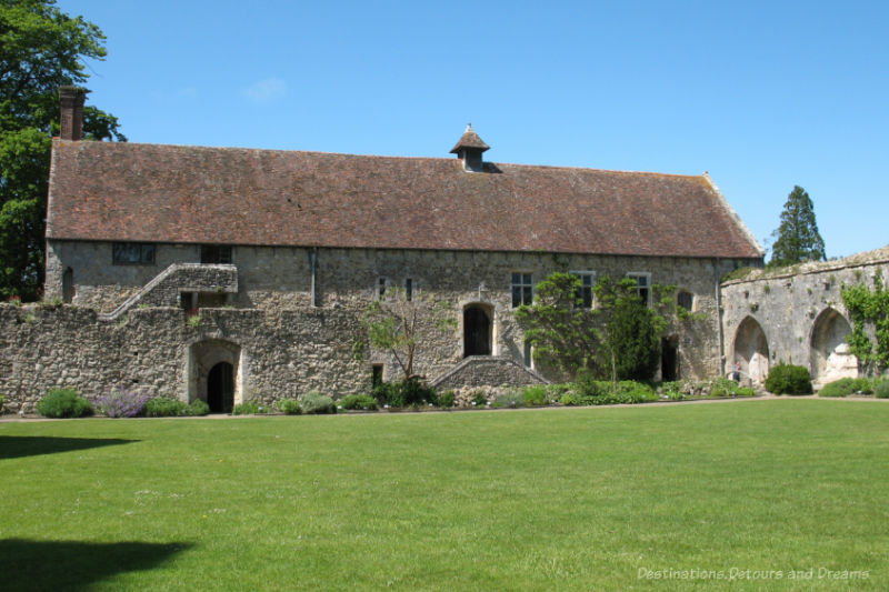 Stone building at edge of grassed cloister that was once part of a Cistercian Abbey