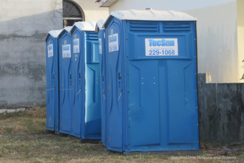 Collection of 4 blue portable toilets