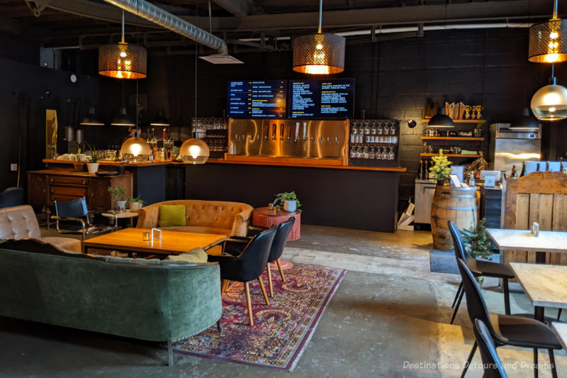 Taproom with tap counter in background and sofa seating in middle of room