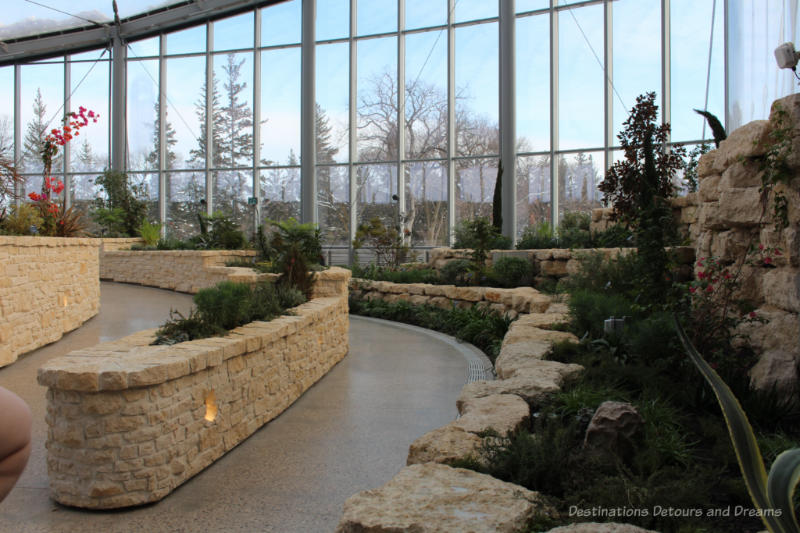 Walkways bordered by stone-edged Mediterranean gardens