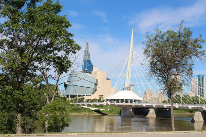 Riel Esplanade pedestrian bridge with view of the Canadian Museum for Human Rights and downtown Winnipeg behind it