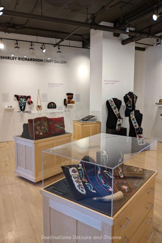 Museum gallery with various displays of Indigenous beadwork
