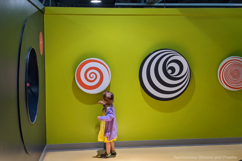 Toddler spinning spirals at a children's museum
