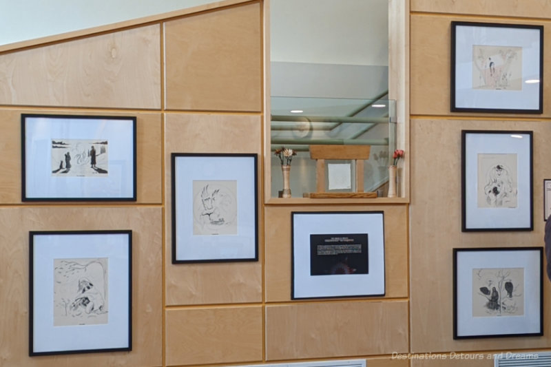 Six framed moon line drawings on display on a light coloured wall