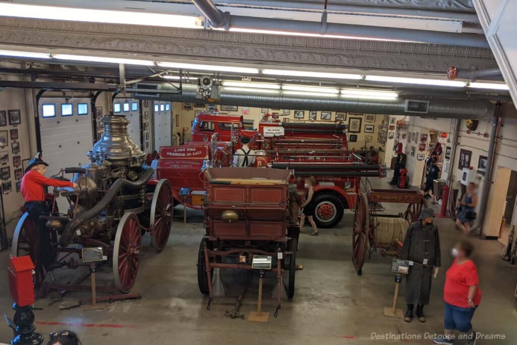 Main floor of firefighters museum containing a variety of vintage firefighting vehicles