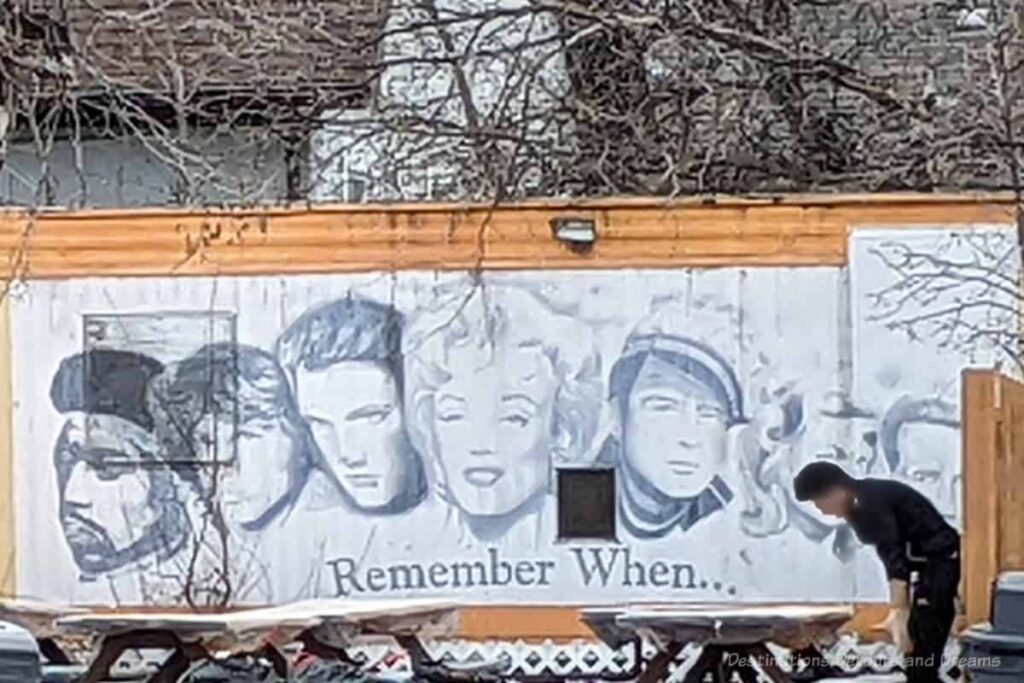 Black and white mural showing faces of 1950s film and music icons