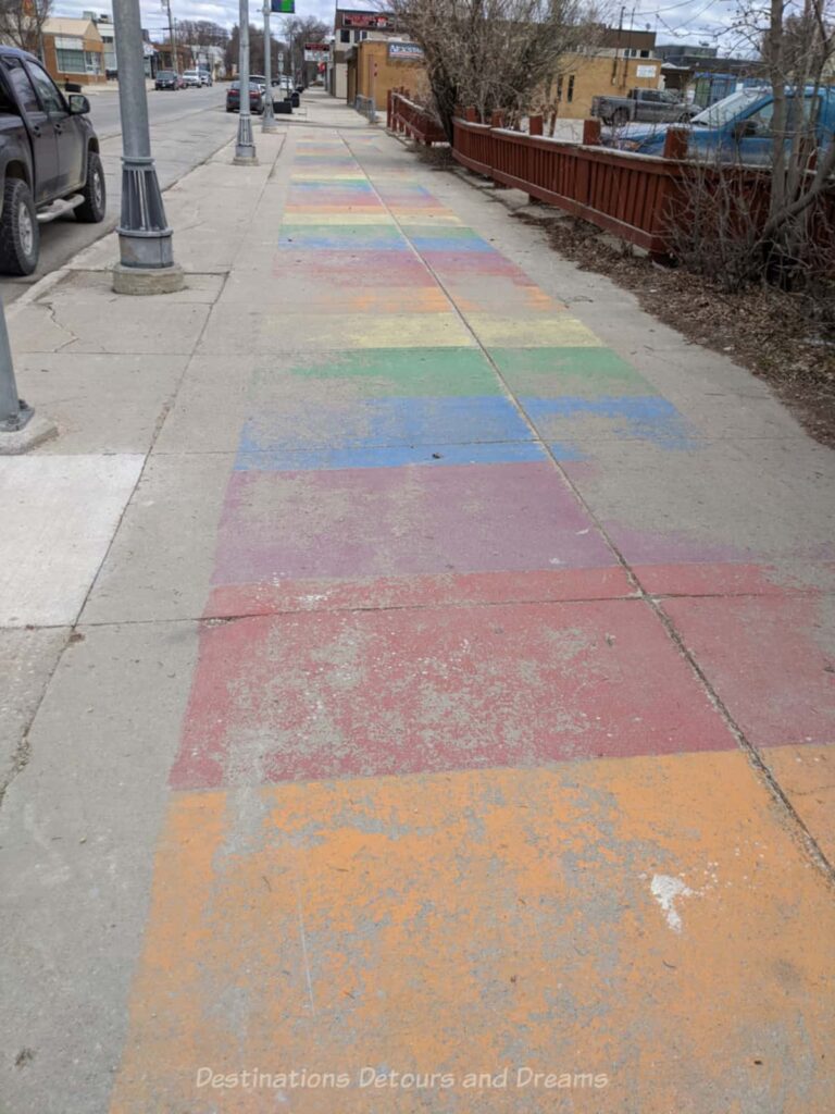 Faded coloured squares painted on a sidewalk
