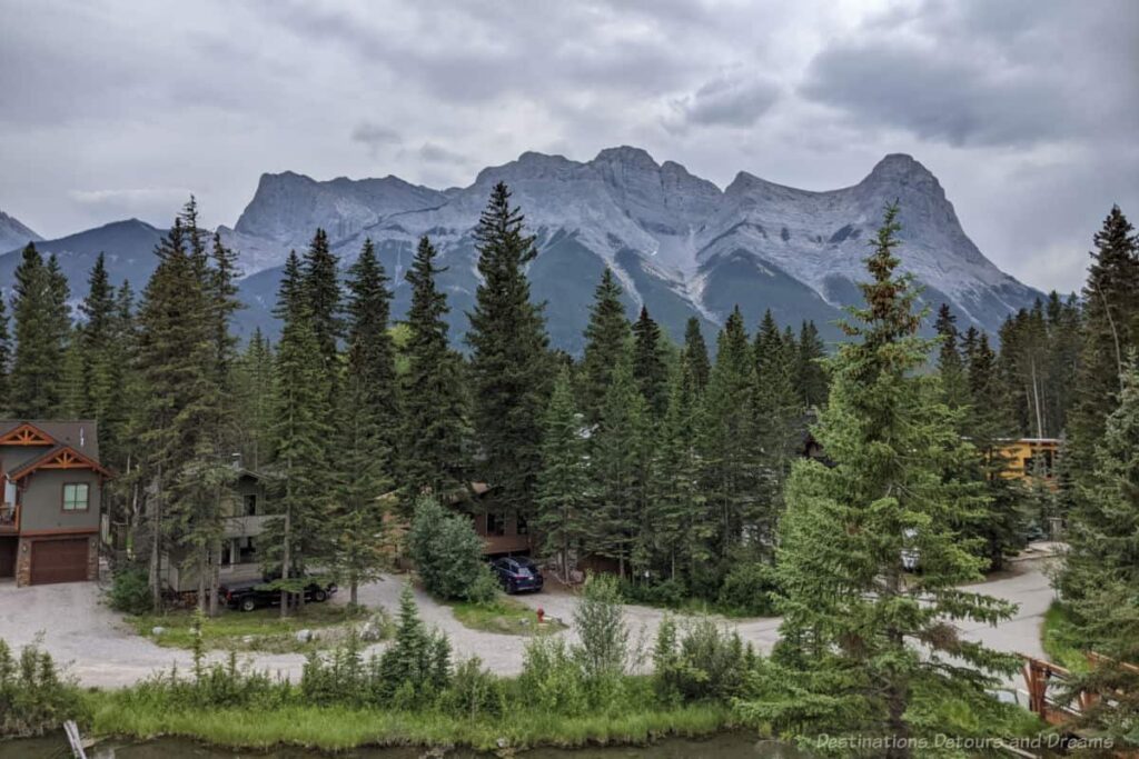 View of Three Sisters Mountain range i Canmore area from The Malcolm pool