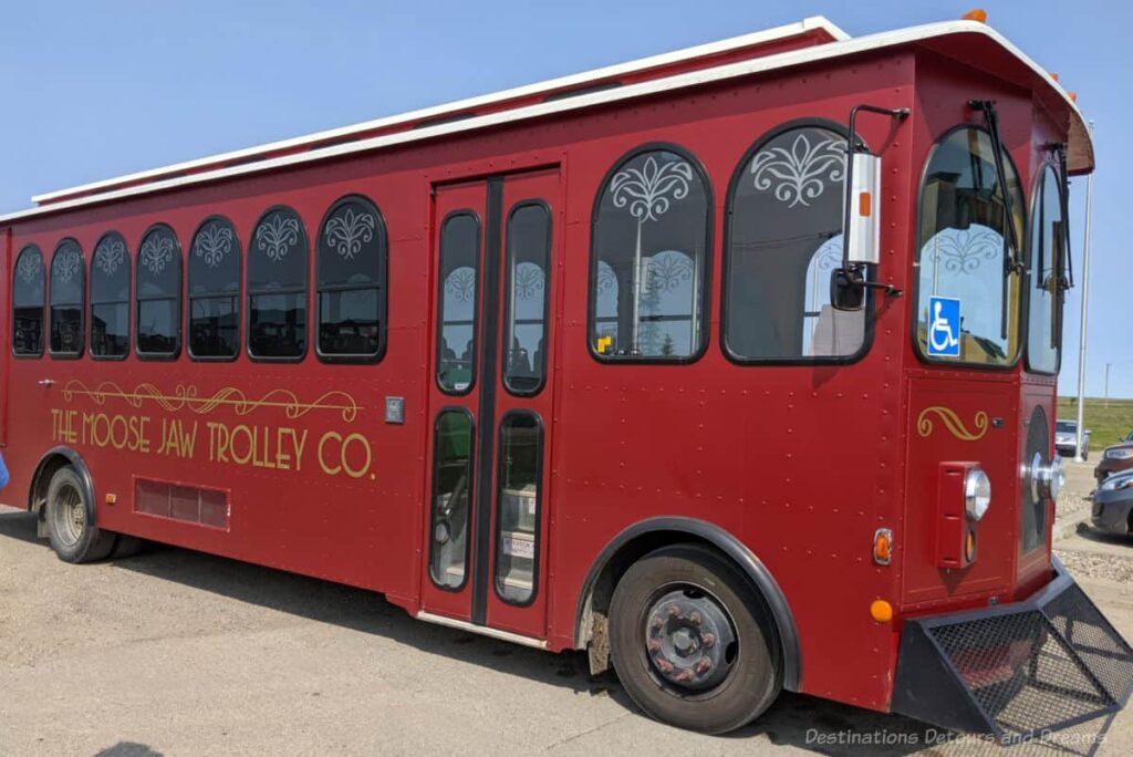 Red trolley-style bus offering city tours of Moose Jaw