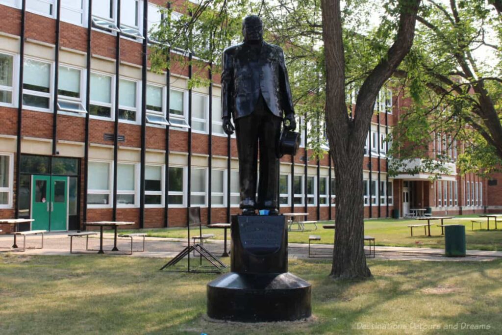 statue of Winston Churchill in front of a school