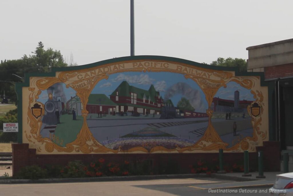 Canadian Pacific Railway mural in Moose Jaw showing an old red station and a steam engine