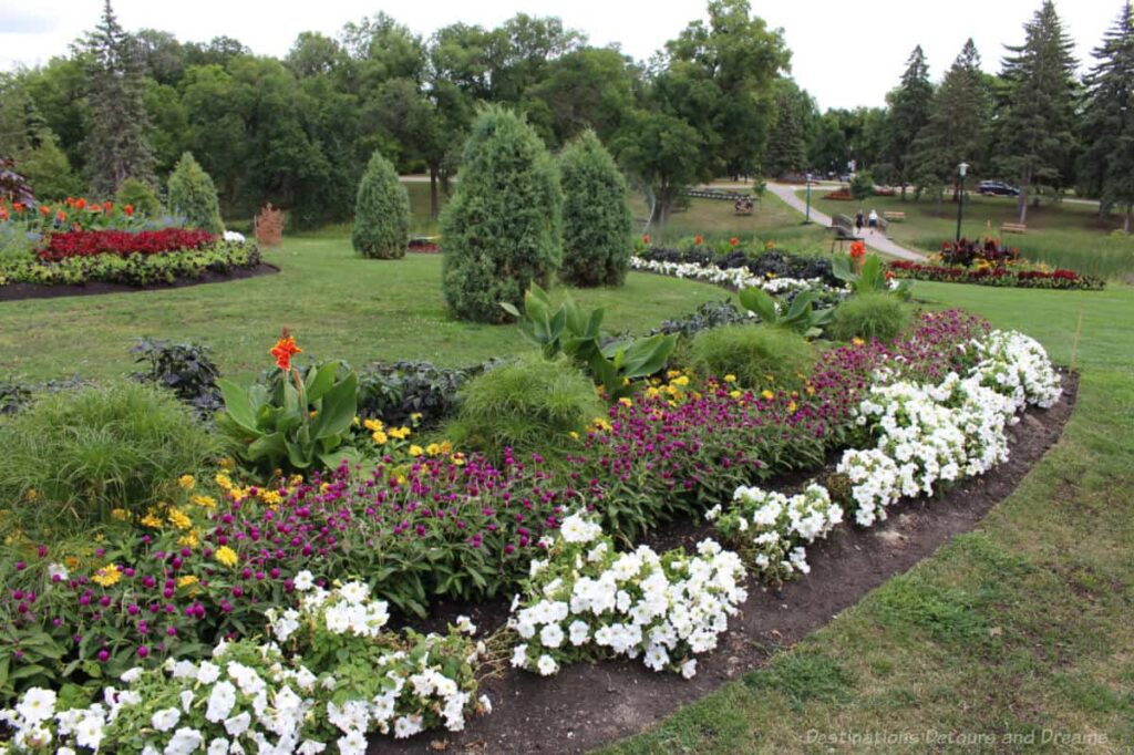 Beds of formal gardens in among green spaces and trees in Kildonan Park, Winnipeg