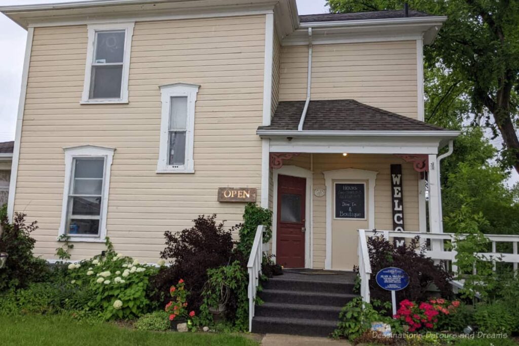 Two-story wooden house now operating as a restaurant and boutique