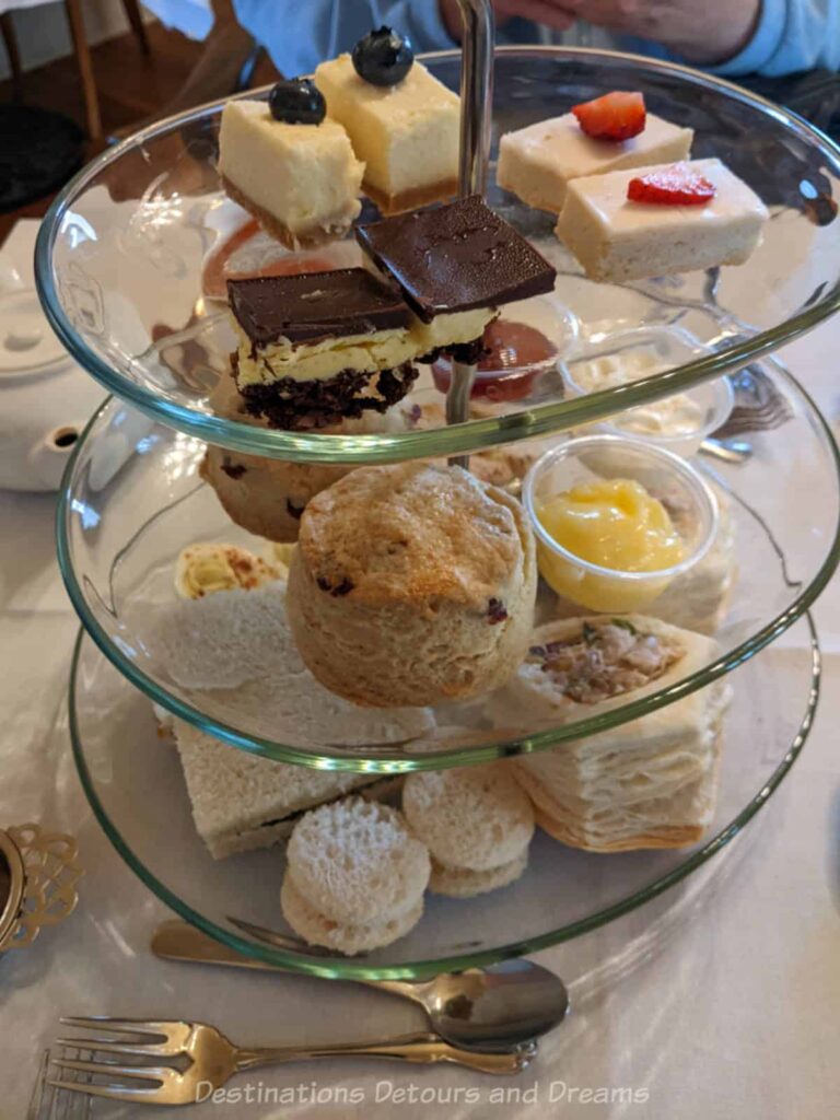 Afternoon tea three-tiered tray of sandwiches, scones, and sweets