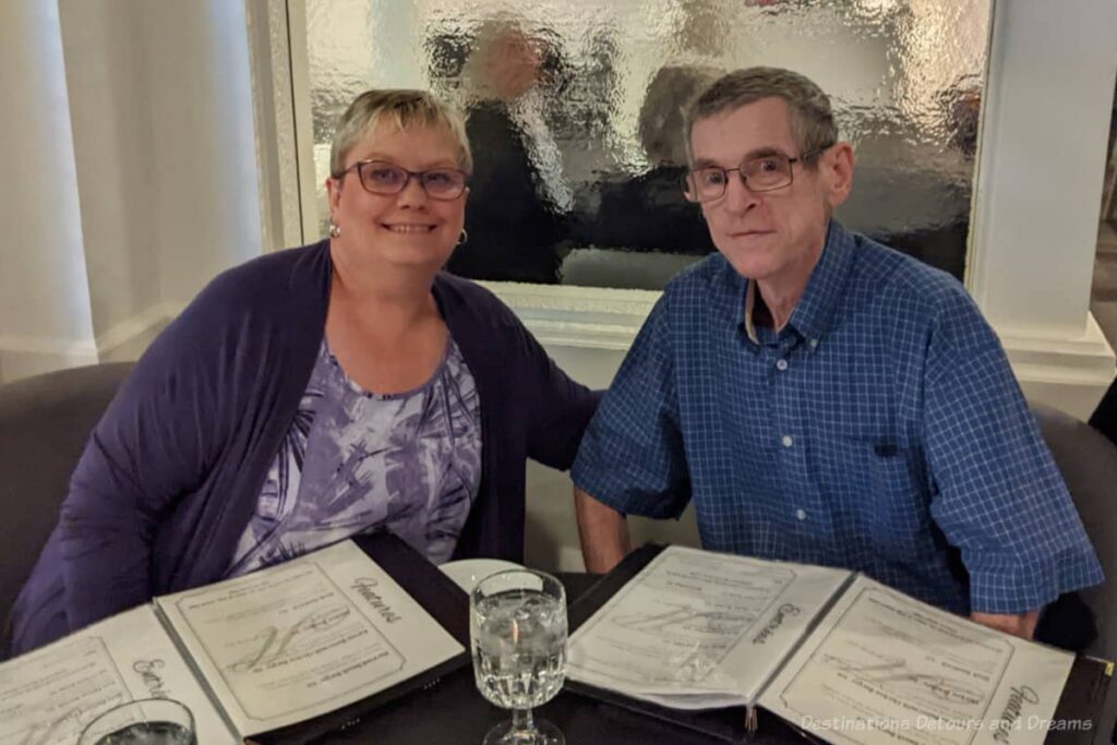 Couple at restaurant table with menus on table