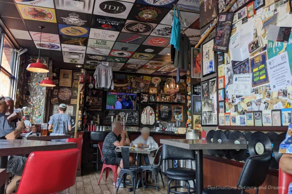 Interior of Rosie's on River Street in Moose Jaw with walls and ceilings covered with posters and memorabilia