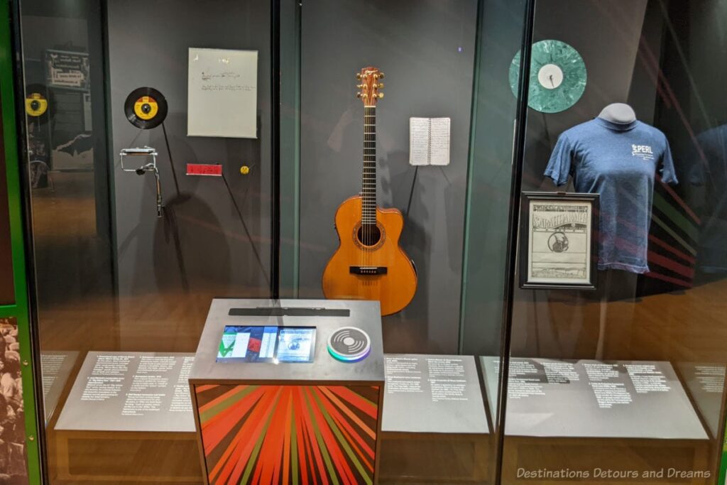 Display cases with harmonica, guitar, t-shirt and more on display at Beyond the Beat
