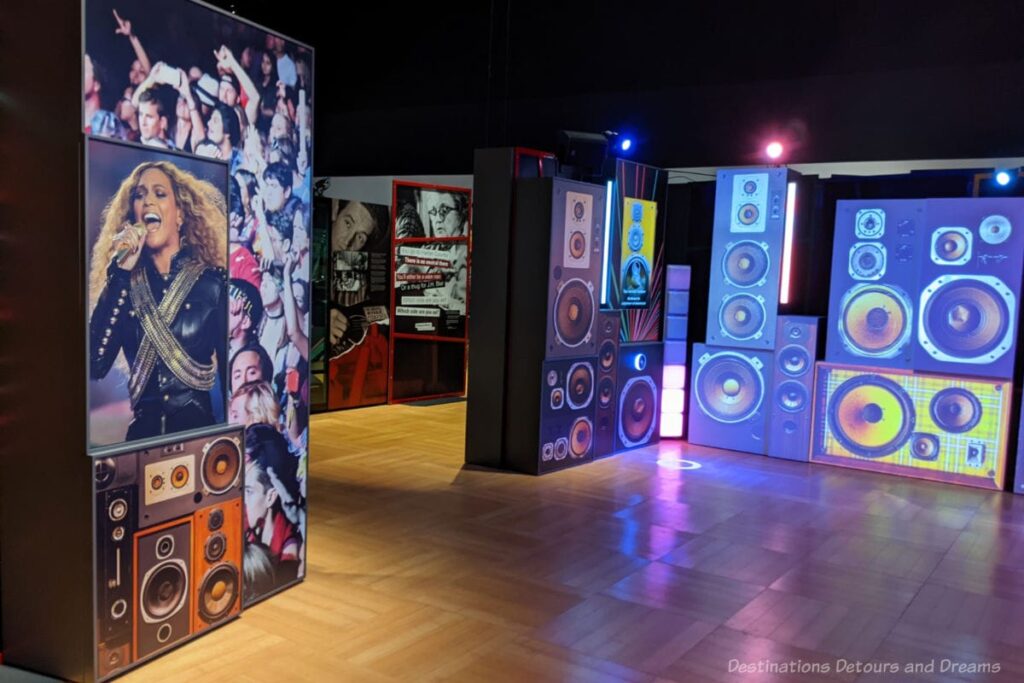 Assorted panels containing colourful photos and pictures of speakers at a music exhibit about human rights
