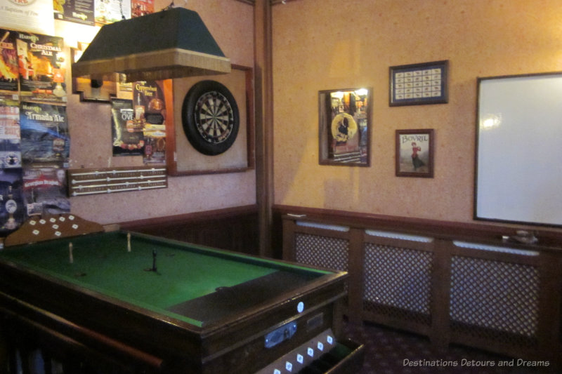 Dart board and bar billiards table in an English pub