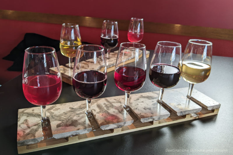 Two wine flights, one with 5 glasses and one behind it with 3