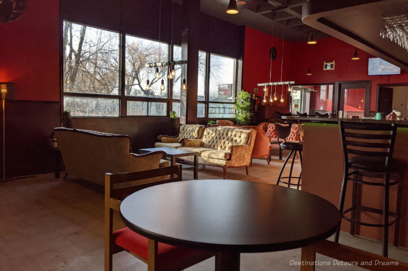 Tasting room with vintage sofas and tables at Shrugging Doctor Beverage Company