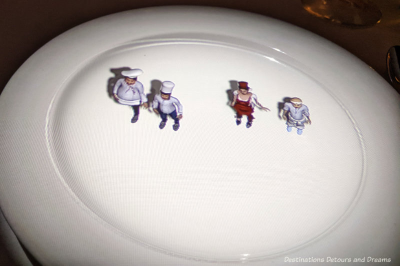 Le Petit Chef Animated Chefs Animated projection of four tiny chefs onto a white dinner plate
