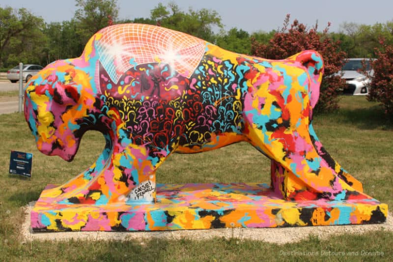 Bison on the Boulevard Excitement Returns Concrete bison painted with splashes of vibrant colours
