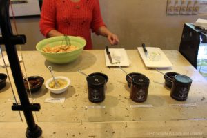 Counter containing plates with soft cheese and a selection of jams