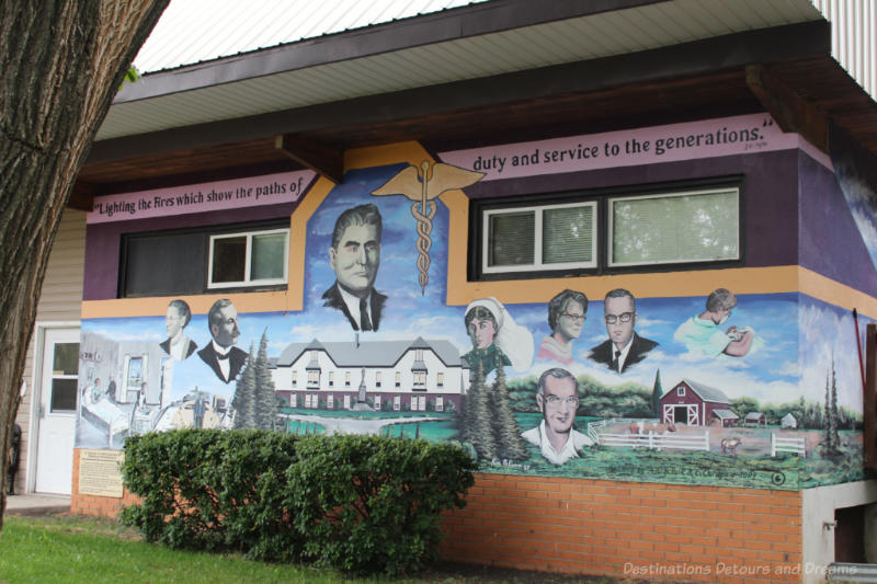Boissevain Outdoor Art Gallery Salute To Medical Professionals Mural on the side of a building shows a hospital, a farm, and portraits of doctors, nurses, vets in a salute to medical professionals