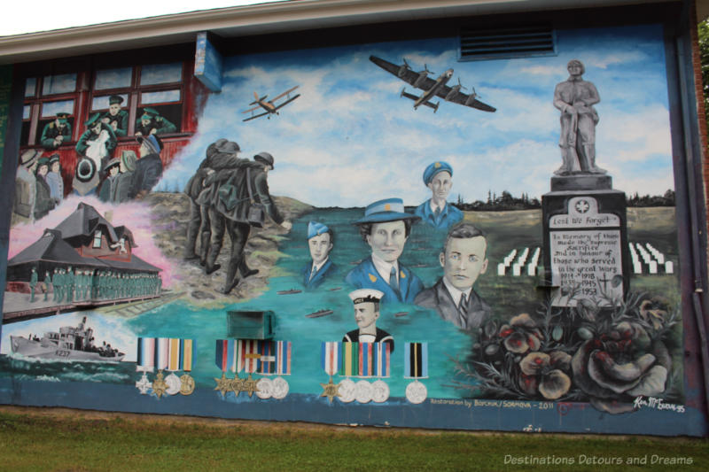 Boissevain Outdoor Art Gallery Royal Canadian Legion Outdoor mural shows portraits of soldiers, a war memorial, planes, medals, troops at a train station, a naval boat in a salute to those who died in war and veterans who returned