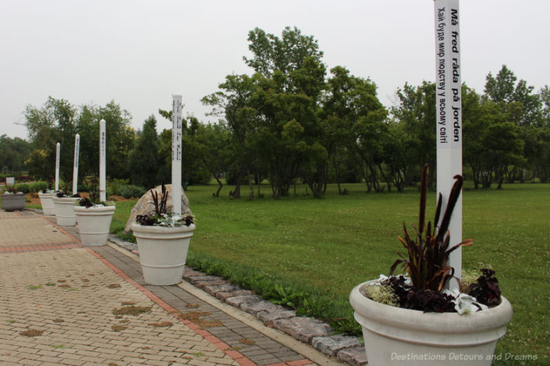 Flower pots in a park contained peace poles