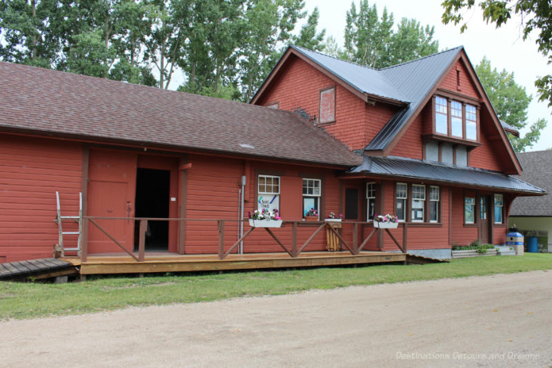 Former train station building painted a rust-red